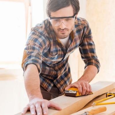 Ellis Lake Group carpenter carefully measuring and cutting wood with precision