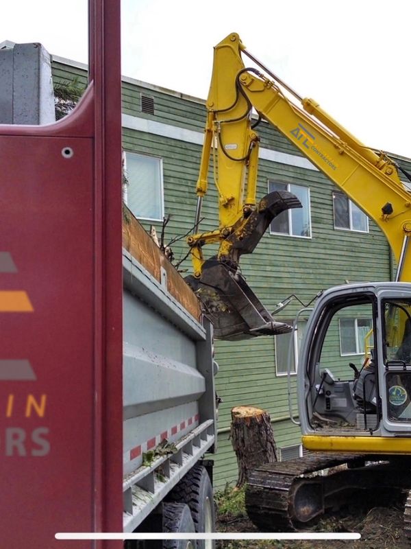 All Terrain Contractors excavator loading debris into dump truck during site demolition and cleanup