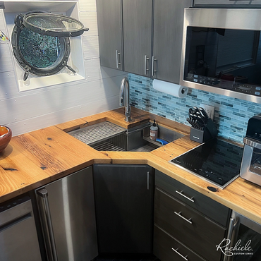 Custom stainless single bowl corner sink in wood countertop with porthole  window by Rachiele 