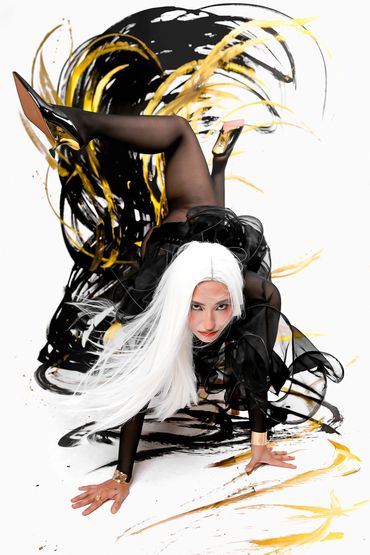 Woman with white hair and black outfit in dynamic pose with paint splashes.