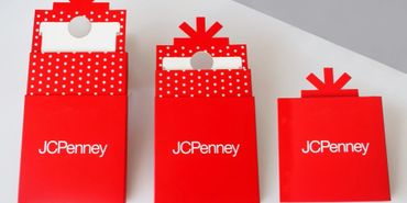 Three red JCPenney gift boxes with white polka dots and bow designs.