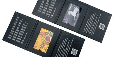 Two black card holders displaying colorful and silver cards.