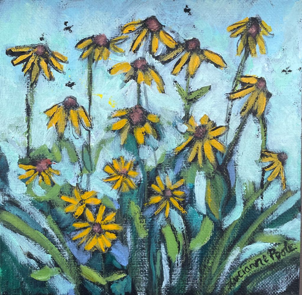 Yellow wild flowers grow against a blue sky.