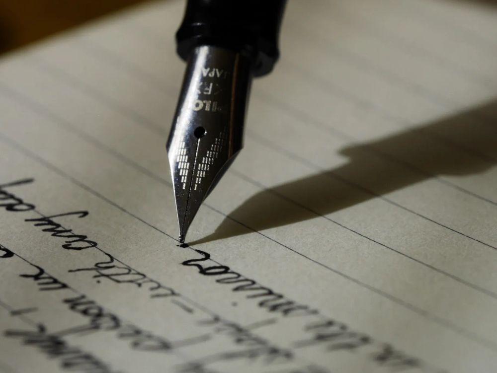 Fountain pen writing in script on lined paper