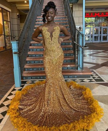 Woman in a glamorous gold sequin gown.