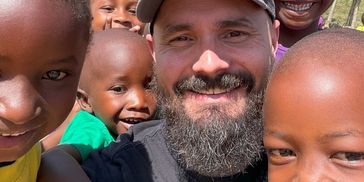 Joe Wilson, founder of Data, M.D., with the kids at Naomi's village. 50% of our profits go toward su