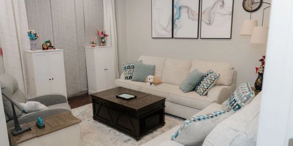Cozy living room with neutral decor and blue accents.