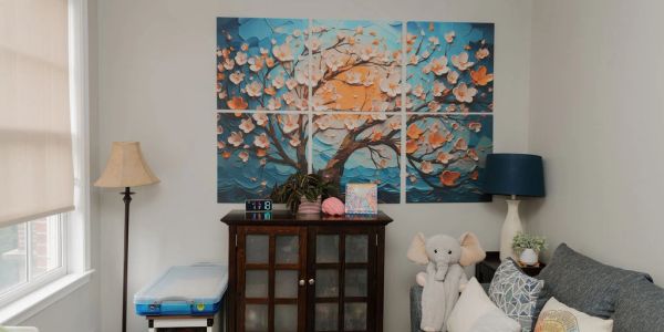 Cozy living room corner with floral wall art and an elephant plush toy.