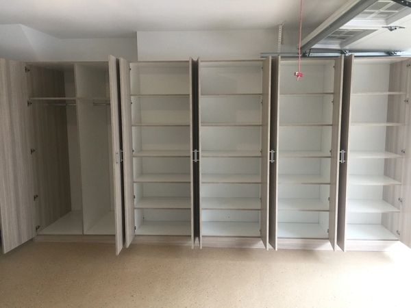 Empty open closets and shelves in a garage or storage space.