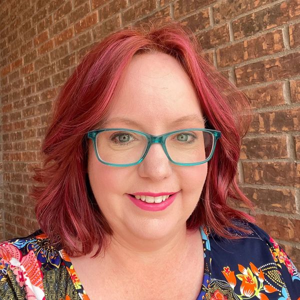 Image of Cheryl Willoughby, MA, LPC-S with pink hair and glasses 