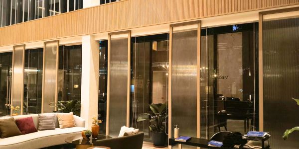 Modern lounge area with large windows and stylish furniture.
