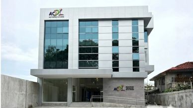 Modern white office building with glass windows and ACYL logo.