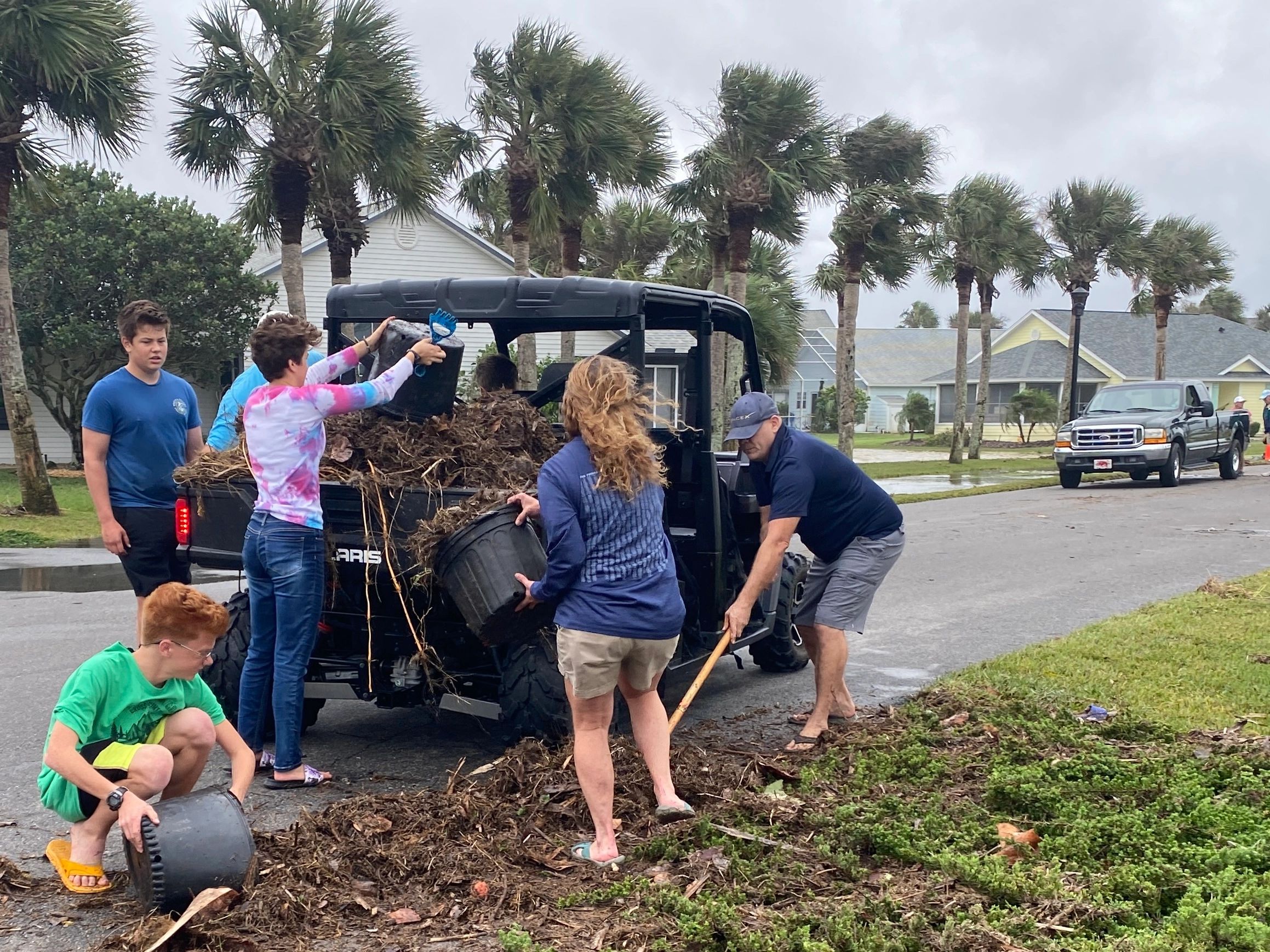 Team of volunteers cleaning up their community after Hurricane Nicole