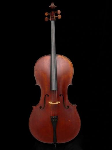 A classical cello with a wooden body against a black background.