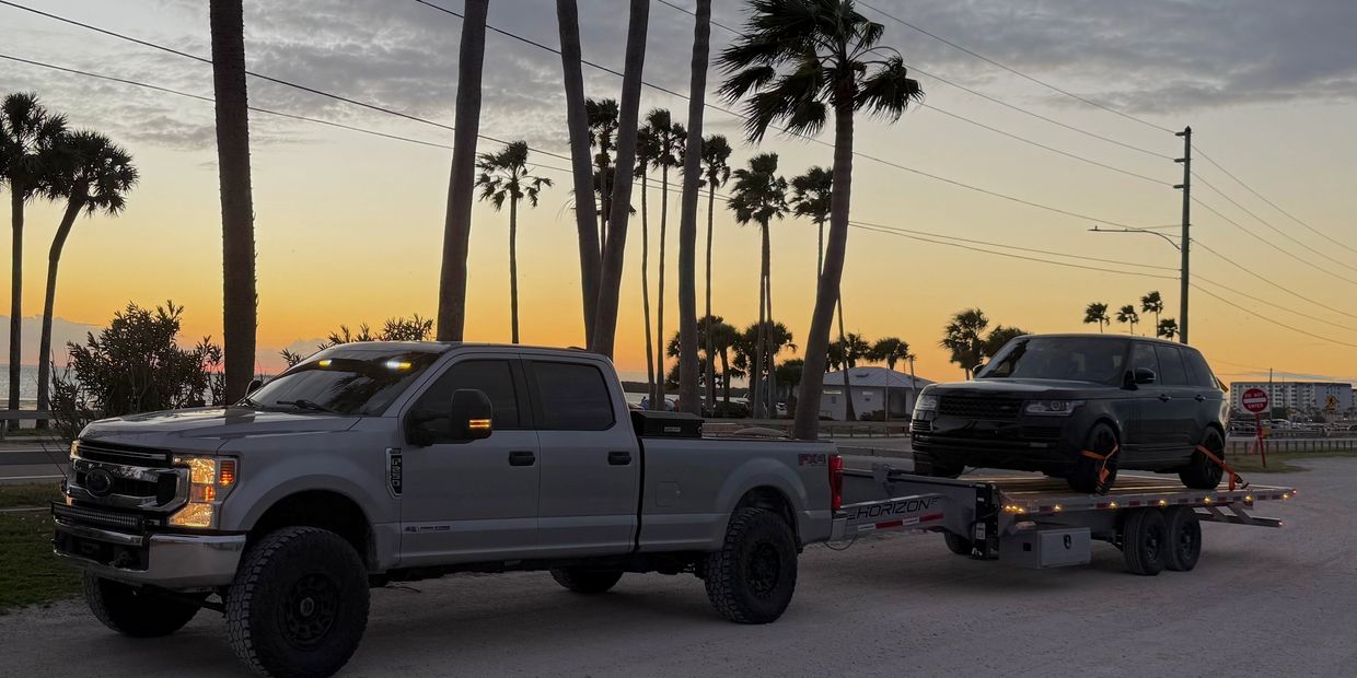 Flatbed towing service in Clearwater Florida near US-19 transporting SUV by Iron Clad Towing