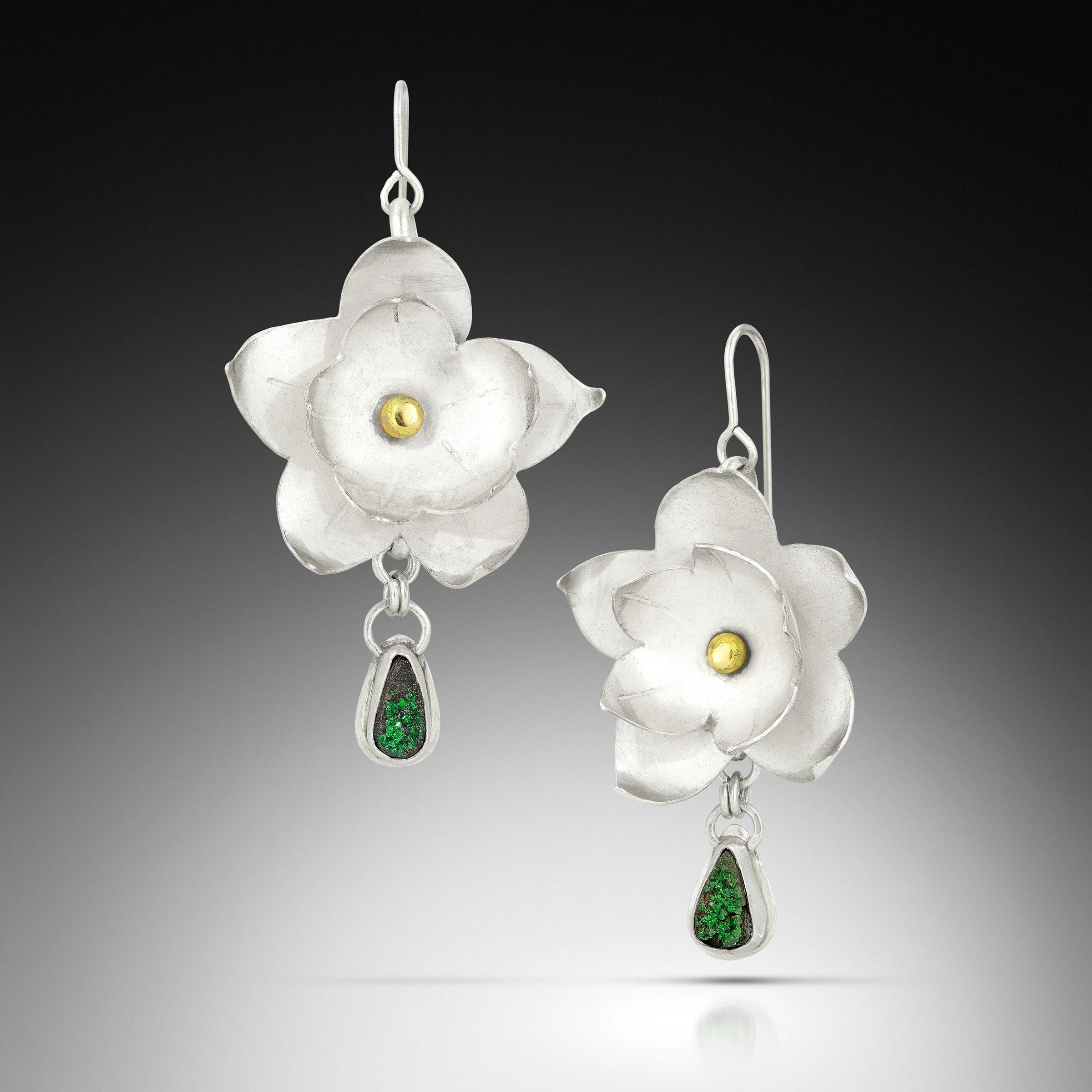 Silver floral earrings with green stone drops and gold accents.