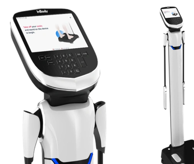 A sleek white and black body composition analyzer with a digital screen and footpads.
