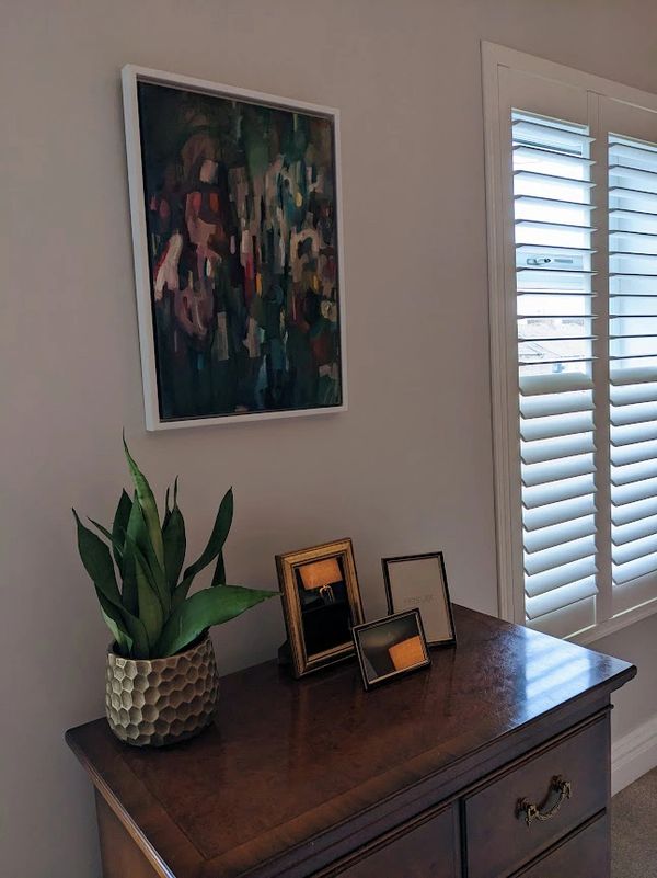 White shutters in bedroom with black out blinds behind