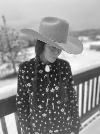 Woman in a cowboy hat with braids.