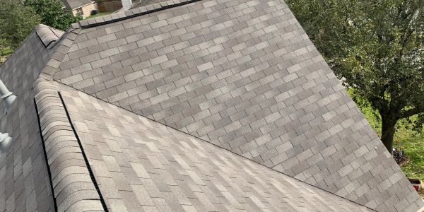 A roof with two different shades of gray shingles.