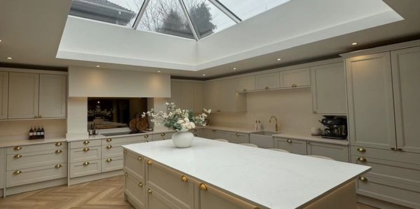 Spacious modern kitchen with a large island and skylight ceiling.