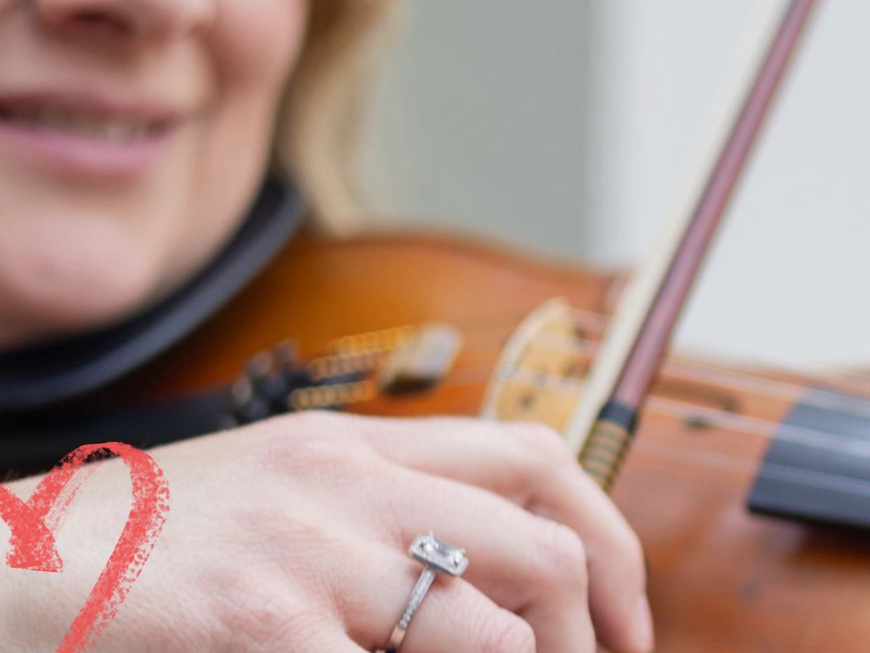 Emily performing on her acoustic violin modelling a ring designed by Share Jewellers in Yorkshire