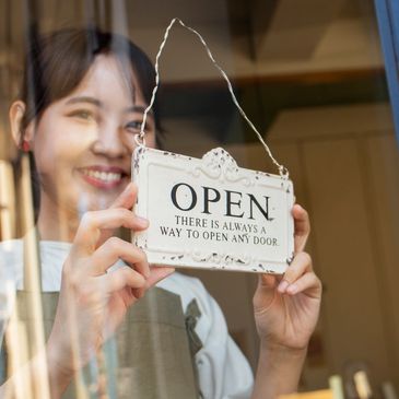 Image by freepik - young woman arranging her cake shop