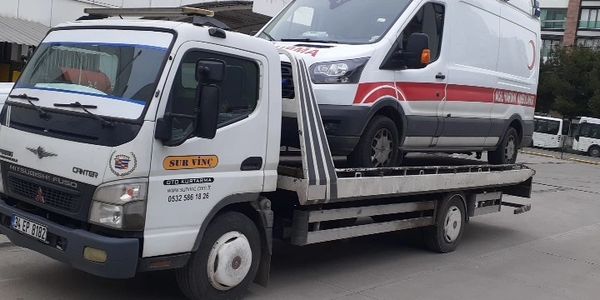 A tow truck transporting a van