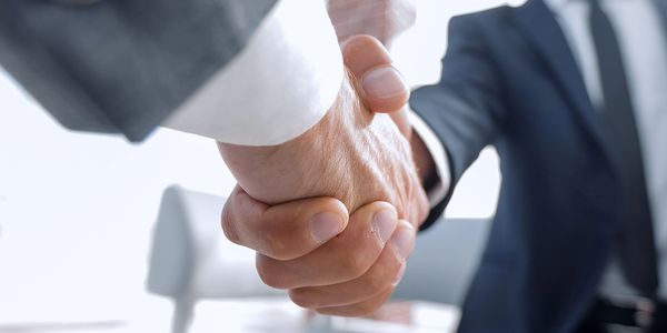 Close-up of two business people shaking hands.
