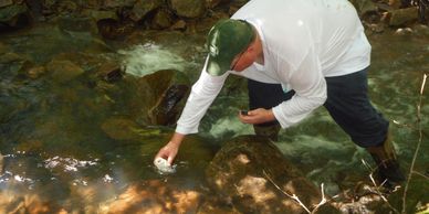 John Dolan, secretary of the CRTU, collects water samples from a tributary to Glade Run in a remote 