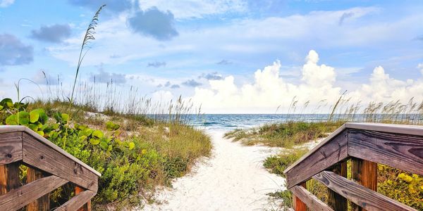 wooden beach entrance onto white sand beach