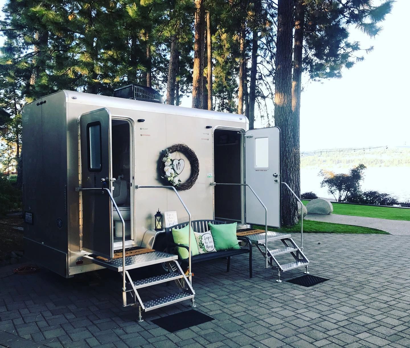 two stall restroom trailer with a view of the lake in the background