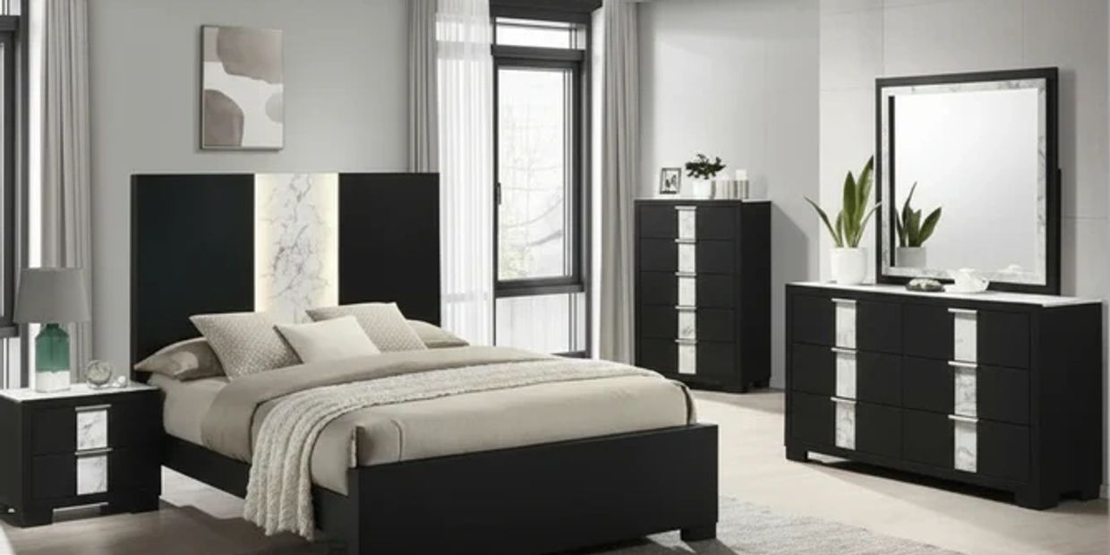 Modern black and beige bedroom set with marble accents and large mirror.