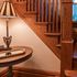 Front entryway with soft lighting and an exquisite and grand wooden staircase