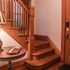 Front entryway with soft lighting and an exquisite and grand wooden staircase