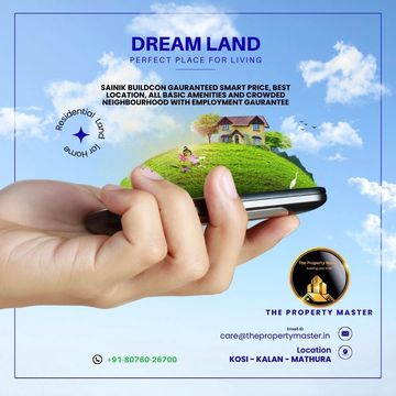 Hand holding a smartphone with a miniature house and green landscape on screen, symbolizing 'Dream Land' housing project.