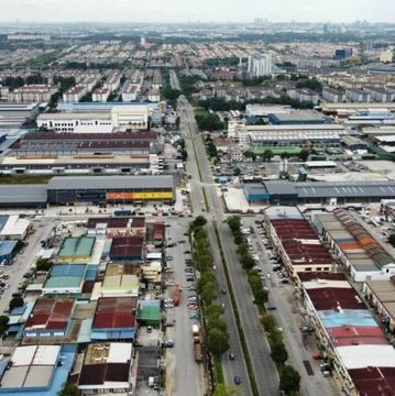Aerial view of a city with roads and industrial buildings.