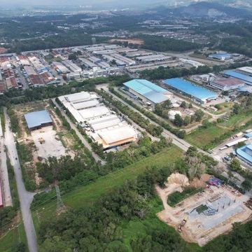 Aerial view of an industrial area with warehouses and greenery.