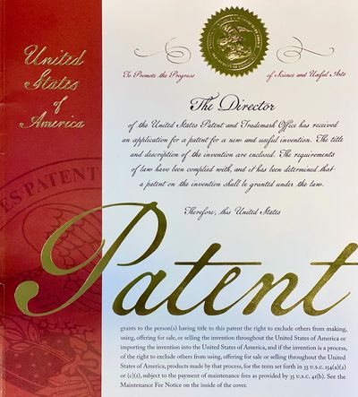 Official United States patent certificate with gold embossed seal and elegant script.