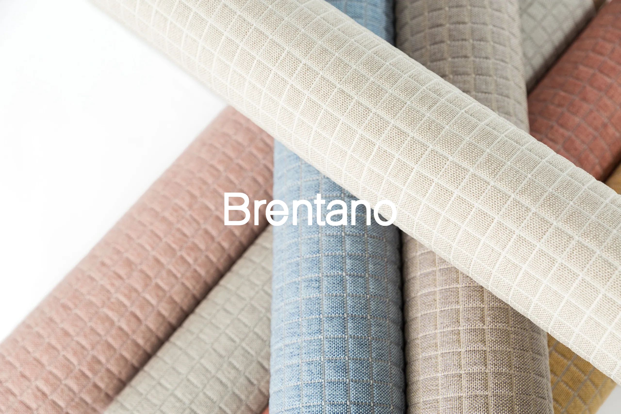 Rolled fabrics with grid pattern in pastel colors.