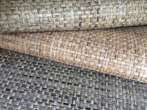 Close-up of textured woven mats in various shades of brown and grey.