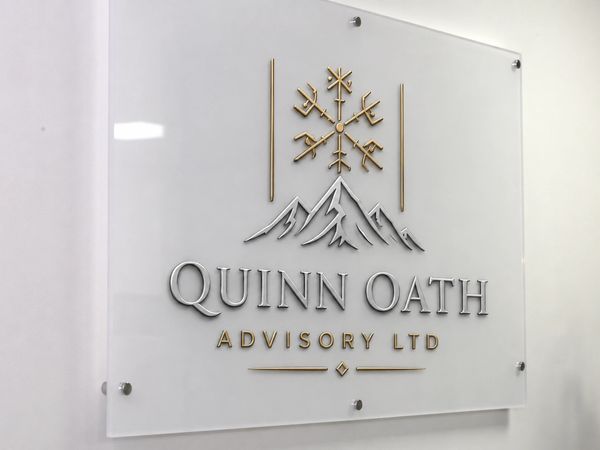 Modern office sign for Quinn Oath Advisory Ltd with mountain and snowflake logo.