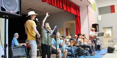 A group of musicians performing on stage with various instruments.