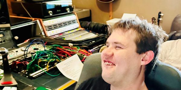 Smiling man in a recording studio.