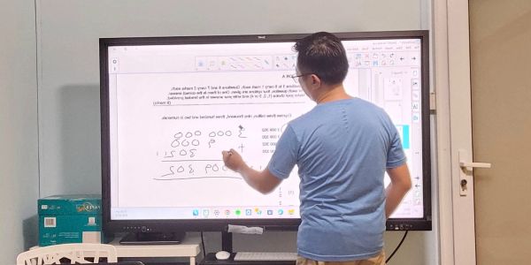 Mr Lawrence Ong teaching Primary Math to students using an interactive whiteboard in Singapore
