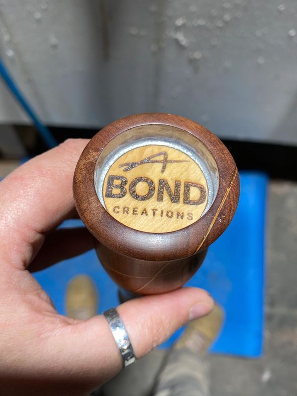 Laser engraved logo and white mica ready for embedding in resin 