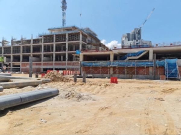 Construction site with building framework and cranes.