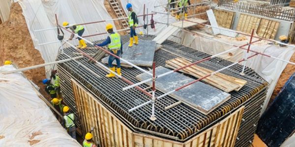 Construction workers assembling a reinforced concrete structure.