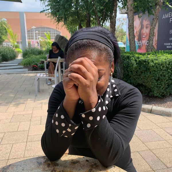 Courage Coach Jess Praying at the Cross County Shopping Center in Yonkers, NY.