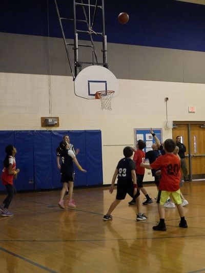 Image of youth playing basketball in gym